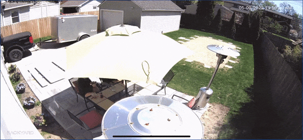 A patio umbrella flys away from the wind